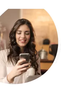 Mulher teleagente olhando para o celular após fechar mais uma venda de Oi Fibra