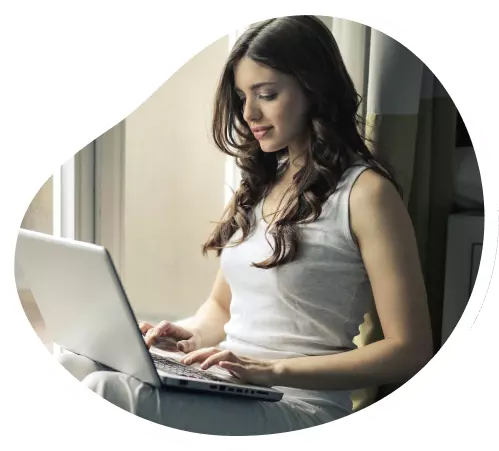Mulher preenchendo no notebook o formulário de parceria Oi Fibra
